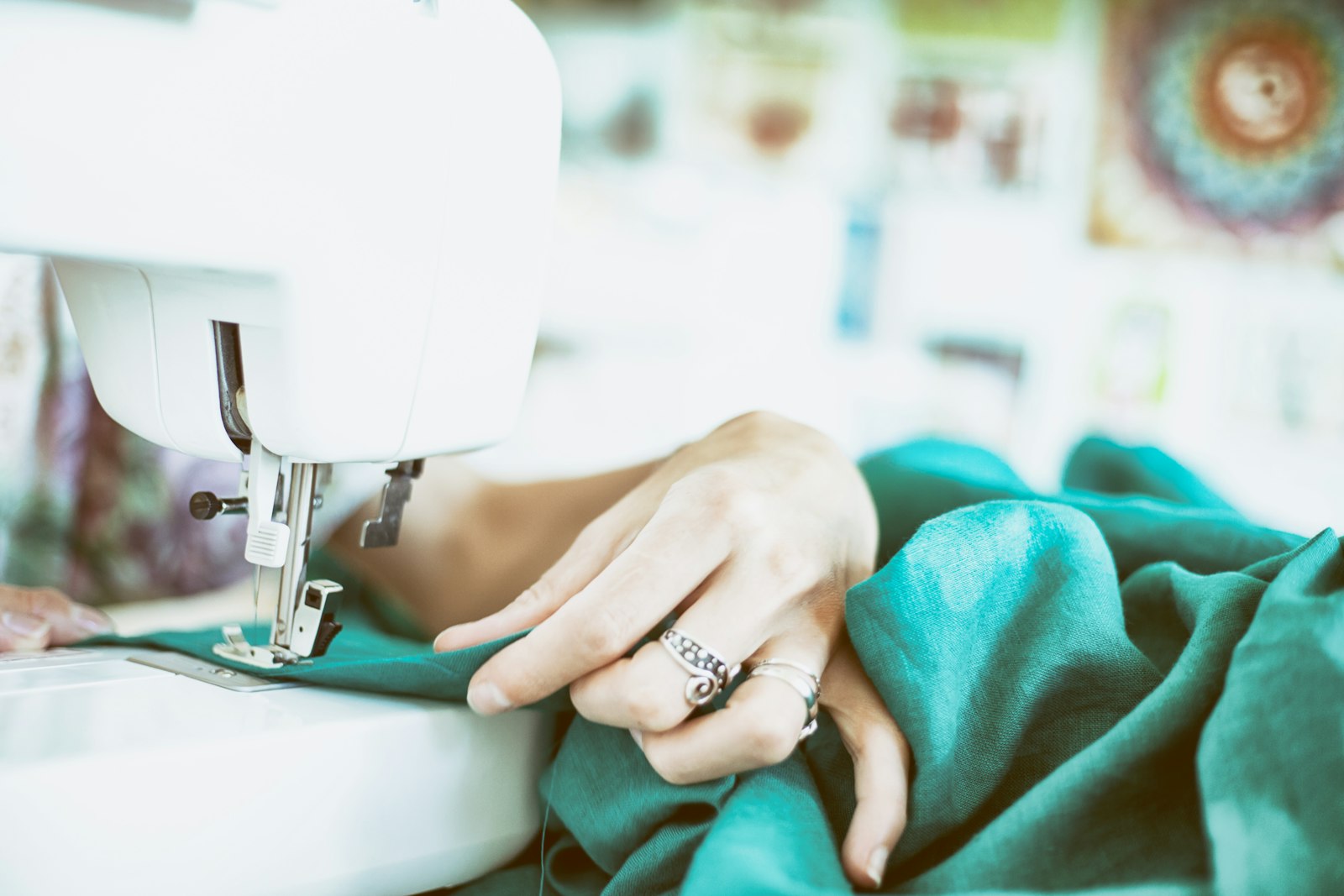 Placeholder: hands at a sewing machine